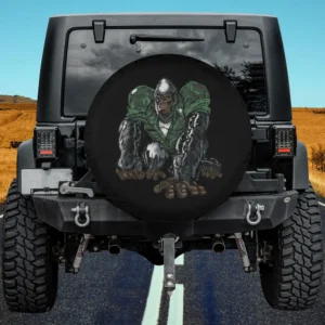 Silverback gorilla in camouflage army jacket crouching on spare tire cover, no camera hole