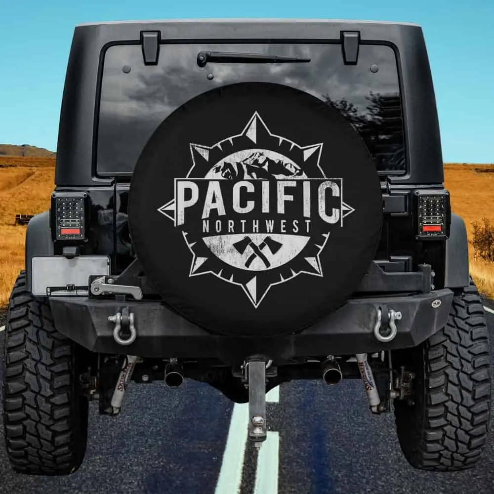 Distressed compass mountain axes Pacific Northwest spare tire cover without camera hole on RV